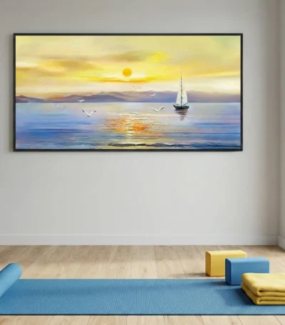 Impressionist seascape hand-painted canvas depicting golden sunset with sailing boat and distant mountains in warm yellows and cool blues, yoga studio setting