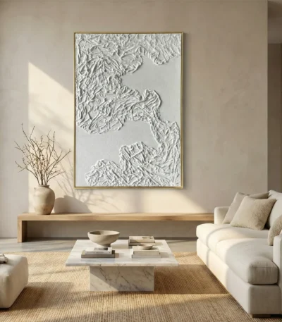 Textured monochromatic hand-painted canvas depicting layered topographic mountain ranges in white and cream, contemporary living space