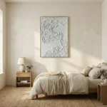 Textured abstract hand-painted canvas with white sculptural relief and organic topographical details, gold-toned frame, contemporary bedroom