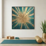 Textured abstract hand-painted canvas with radiating gold and teal brushstrokes converging at center, yoga studio setting