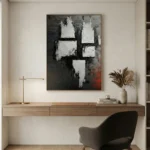 Textured abstract hand-painted canvas with white gestural marks and dark charcoal tones, contemporary workspace