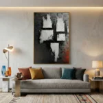 Gestural abstract hand-painted canvas with white impasto marks and charcoal tones, accented by deep red undertones, contemporary living space