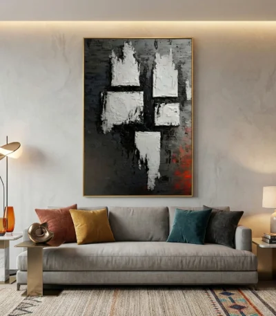 Gestural abstract hand-painted canvas with white impasto marks and charcoal tones, accented by deep red undertones, contemporary living space