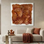 Textured abstract hand-painted canvas with layered burnt orange and terracotta tones, contemporary living space