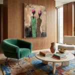 Gestural abstract hand-painted canvas featuring pink blooms and green vessel forms in layered earth tones, modern living space
