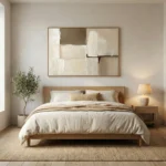 Minimalist abstract hand-painted canvas in cream and taupe with gestural brushstrokes and layered composition, contemporary bedroom