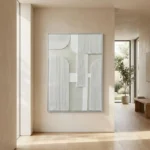 Minimalist hand-painted canvas with geometric white and textured grey forms, neutral cream palette, contemporary entryway