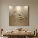 Textured abstract hand-painted canvas depicting layered mountain peaks in monochromatic cream and taupe tones, contemporary dining space