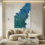 Textured abstract hand-painted canvas in layered teal and blue gestural brushstrokes, contemporary living space