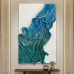 Textured abstract hand-painted canvas in layered teal and deep blue brushstrokes, contemporary interior setting