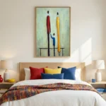 Contemporary figurative hand-painted canvas depicting three stylized figures in red, blue, and yellow tones, modern bedroom