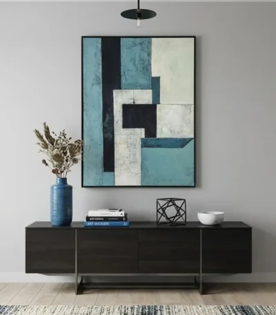 Layered abstract hand-painted canvas in teal, cream, and black geometric forms, modern living space