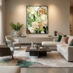 Contemporary floral hand-painted canvas with layered white and coral blooms in soft green tones, modern living space