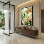 Contemporary hand-painted canvas of layered florals in cream, blush and sage tones, modern entryway