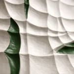 Textured abstract hand-painted canvas with curved geometric forms in cream and sage green tones, contemporary interior