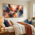 Gestural abstract expressionist hand-painted canvas in vibrant reds, blues, and golds with dynamic brushstrokes, modern bedroom setting
