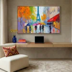 Impressionist hand-painted canvas depicting rainy Parisian street with colorful umbrellas and figures in vibrant orange, blue, and purple tones, contemporary workspace