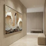 Textured abstract hand-painted canvas in cream and warm earth tones with gestural white brushwork, contemporary interior