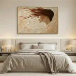 Textured hand-painted canvas of a woman's profile with flowing auburn hair in cream and warm earth tones, contemporary bedroom setting