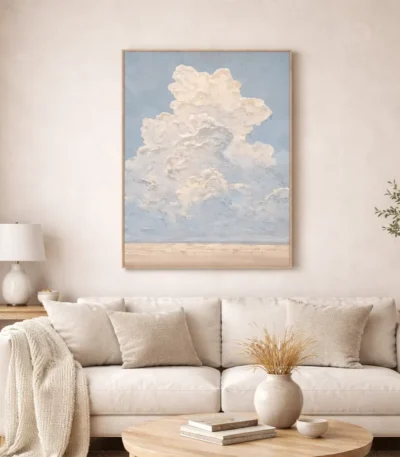 Impressionist hand-painted canvas depicting towering cumulus clouds against soft blue sky and sandy horizon, contemporary living space