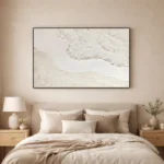 Textured minimalist hand-painted canvas depicting soft coastal waves in cream and ivory tones, contemporary bedroom setting