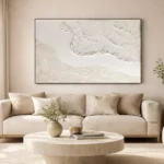 Textured abstract hand-painted canvas depicting layered coastal waves in cream and ivory tones, contemporary living space