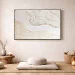Textured minimalist hand-painted canvas depicting coastal waves and sandy shoreline in cream and ivory tones, contemporary meditation space