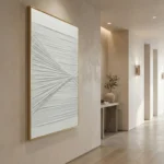 Textured abstract hand-painted canvas with radiating linear patterns in soft white and gray tones, contemporary hallway setting