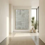 Textured abstract hand-painted canvas with geometric woven pattern in soft grays and whites, contemporary entryway