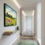 Impressionist landscape hand-painted canvas depicting wildflower meadow with evergreen trees and cloudy sky in golden greens and purples, modern hallway