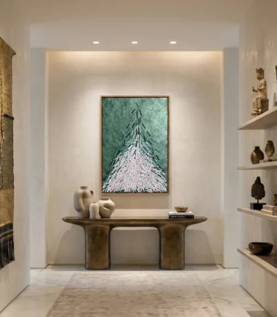 Contemporary abstract hand-painted canvas depicting upward-pointing evergreen tree in teal and white, styled gallery space