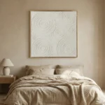Minimalist hand-painted canvas featuring concentric circular patterns in soft gray and cream tones, modern bedroom
