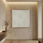 Minimalist hand-painted canvas with concentric circular patterns in soft grey and cream, contemporary entryway