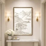 Minimalist hand-painted canvas depicting gnarled tree and layered mountains in monochromatic sepia ink, contemporary entryway