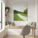 Contemporary landscape hand-painted canvas depicting rolling green meadows, winding river, and snow-capped mountain in soft muted tones, modern workspace