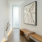 Gestural abstract hand-painted canvas in radiating cream and taupe strokes, modern hallway setting