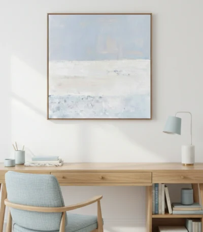 Minimalist landscape hand-painted canvas in soft blue and cream tones with layered horizons, contemporary workspace