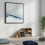 Abstract hand-painted canvas depicting layered horizons in cool blues, whites, and soft grays, yoga studio setting