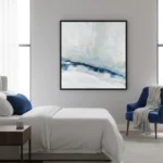 Abstract landscape hand-painted canvas in soft blues and whites with gestural brushwork, modern bedroom setting