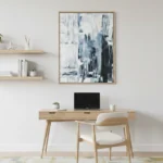Gestural abstract hand-painted canvas in layered blues and blacks with white accents, contemporary workspace