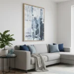 Gestural abstract hand-painted canvas in layered blue and white tones with expressive brushwork, contemporary living space