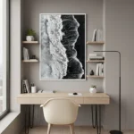 Monochromatic hand-painted canvas depicting abstract facial profile in contrasting black and white tones, contemporary workspace
