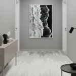 Monochromatic abstract hand-painted canvas with gestural brushstrokes in black and white, contemporary entryway
