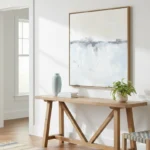 Minimalist landscape hand-painted canvas in soft blues and grays depicting distant cityscape and water, contemporary entryway