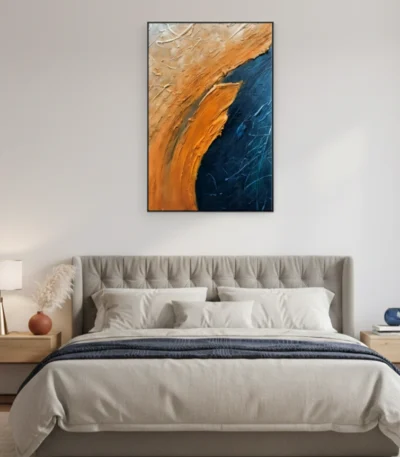 Textured abstract hand-painted canvas in warm ochre and deep navy with gestural brushstrokes, modern bedroom setting