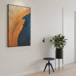 Textured abstract hand-painted canvas in burnt orange and deep navy with gestural brushstrokes, contemporary interior
