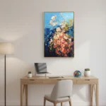 Impressionist hand-painted canvas depicting cascading roses in coral, cream and deep blue tones, styled in a contemporary workspace