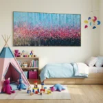 Gestural abstract hand-painted canvas depicting blooming wildflowers in pink, blue and gold tones, children's bedroom