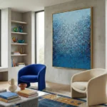 Textured abstract hand-painted canvas in layered blues and whites with gestural marks, contemporary living space