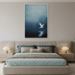 Minimalist hand-painted canvas depicting a solitary white crane in flight over dark water, cool blue and black tones, modern bedroom setting